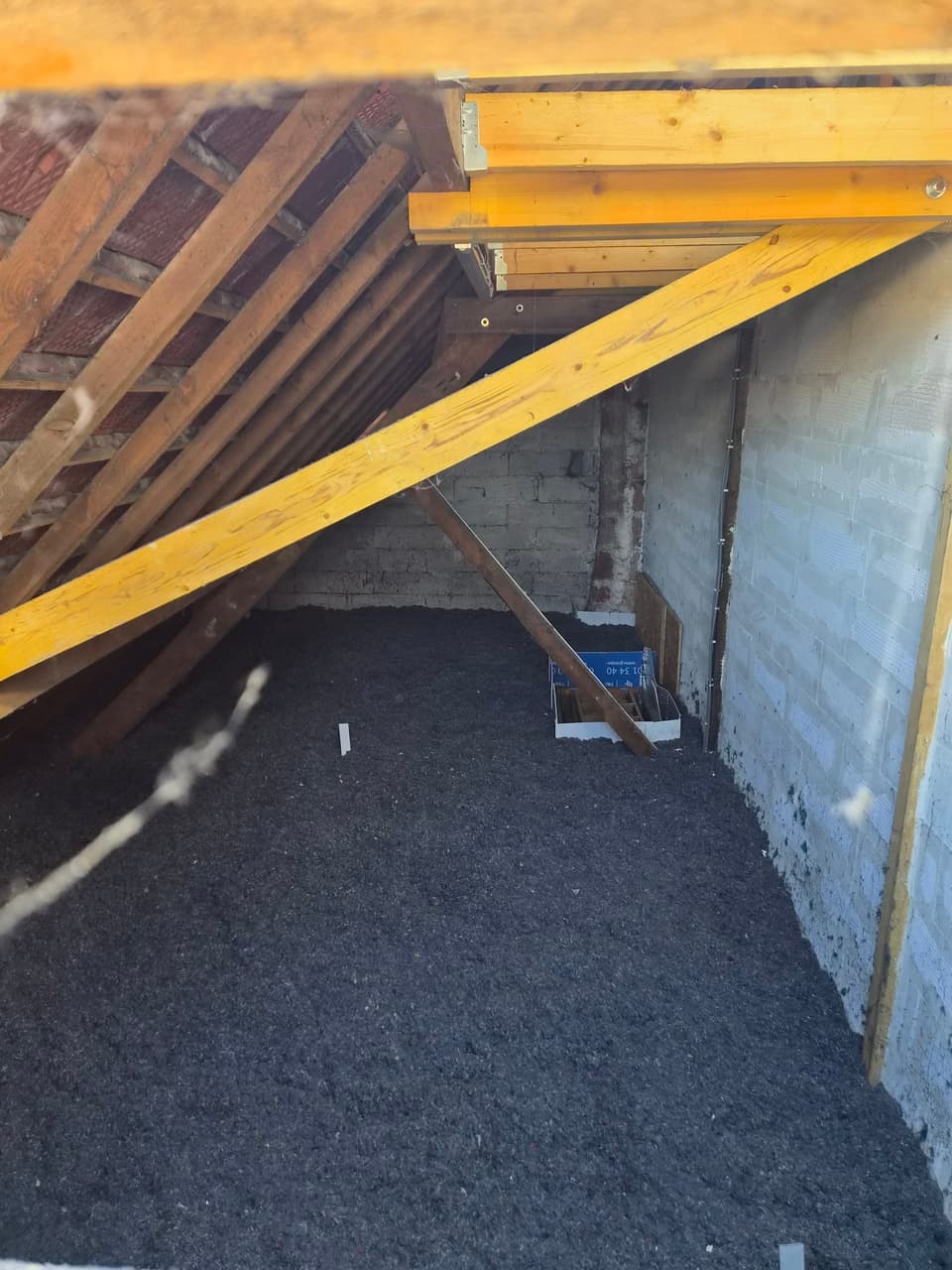 Combles avec charpente renforcée et isolant soufflé réparti sur tout le plancher